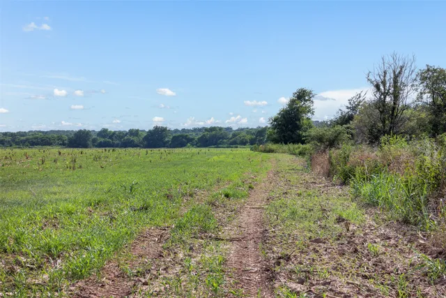 a view of a lake with beach and city view