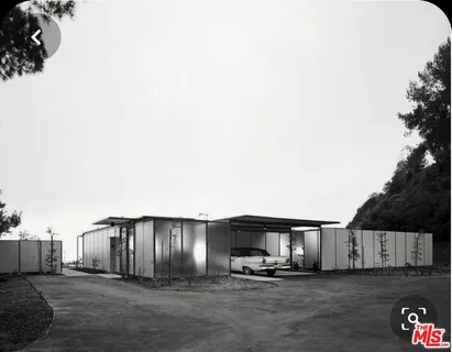 a view of a house with backyard and trees