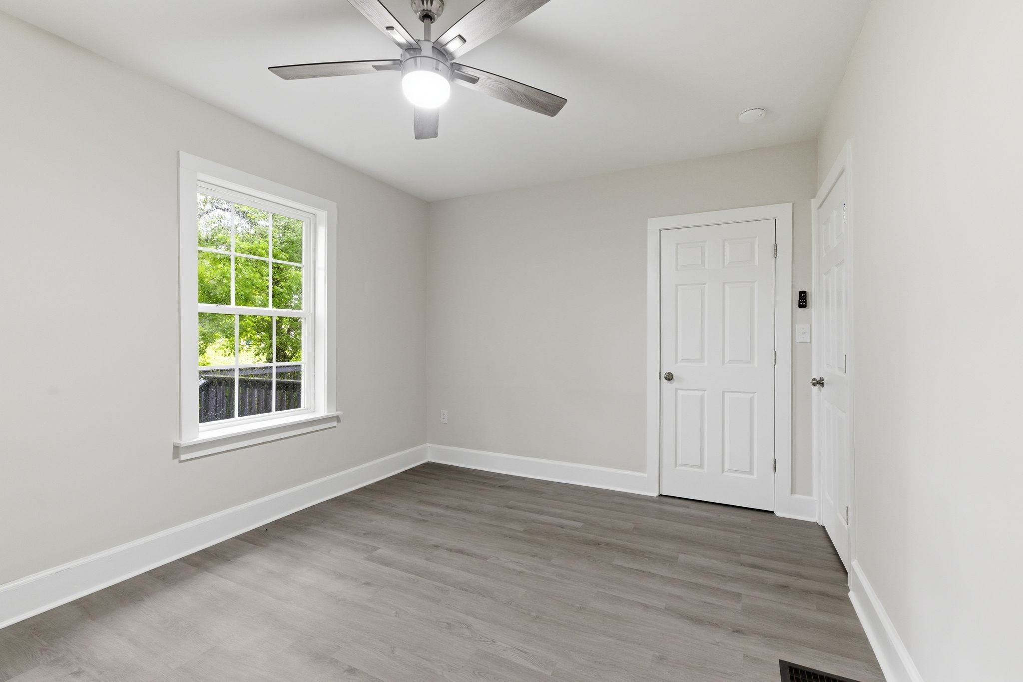 305 South Irwin Street Manchester, TN 37355 - Photo 26 of 40 a view of an empty room with wooden floor and window