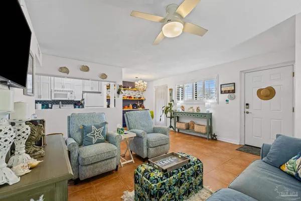 a living room with furniture flat screen tv and a fireplace