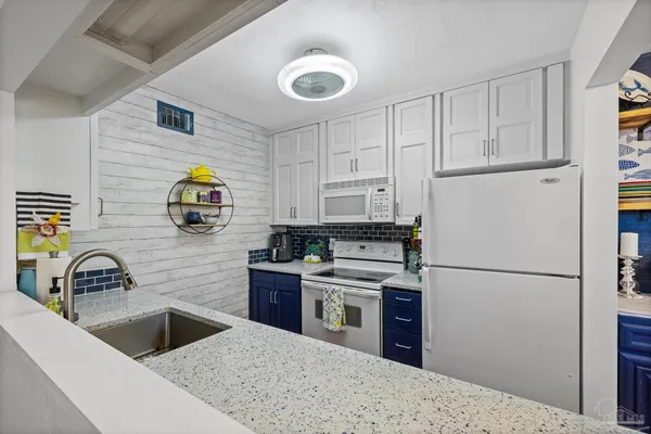 a kitchen with a sink appliances and cabinets