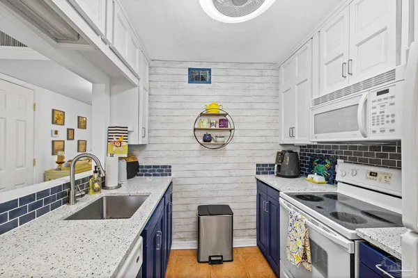 a kitchen with stainless steel appliances granite countertop a sink and a stove