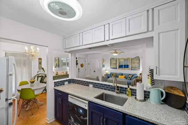 a kitchen with a refrigerator and a sink