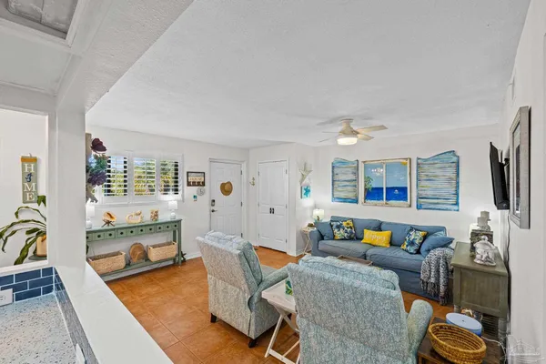 a living room with furniture and a flat screen tv