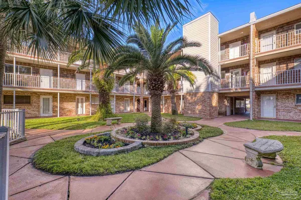 a front view of a house with fountain and outdoor seating