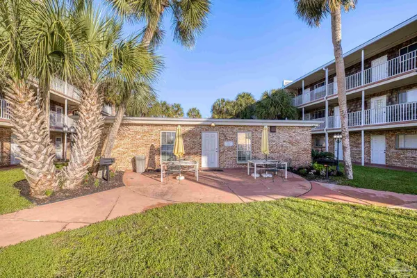 a view of a backyard with a patio and outdoor seating