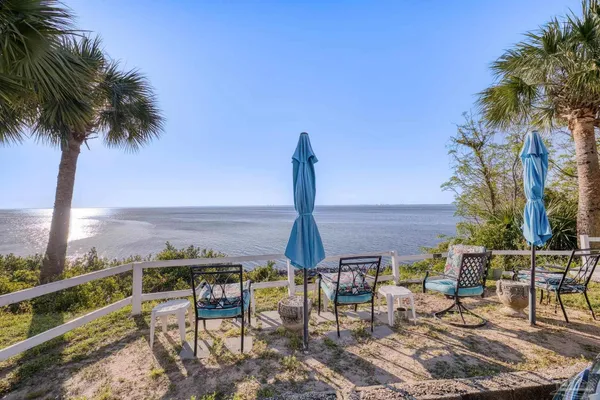 an ocean view with outdoor seating