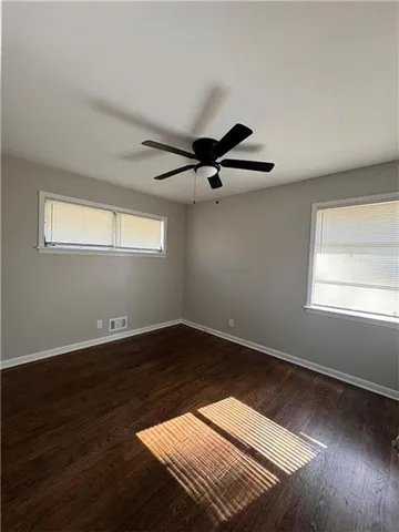 a view of wooden floor and windows in a room