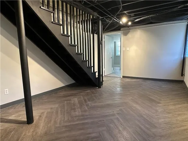 a view of an empty room with wooden floor