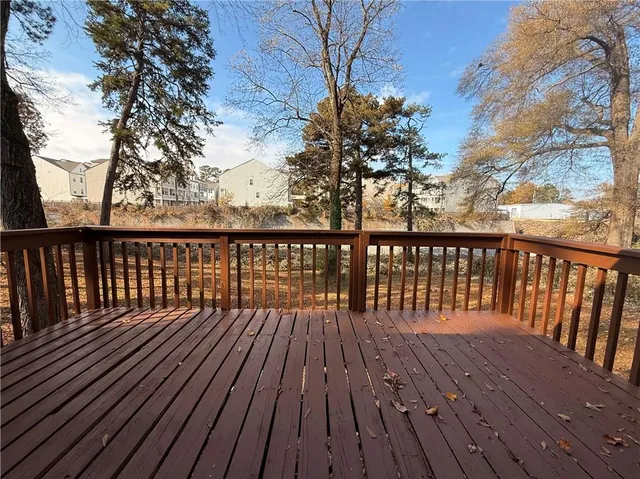 a balcony with wooden floor and fence