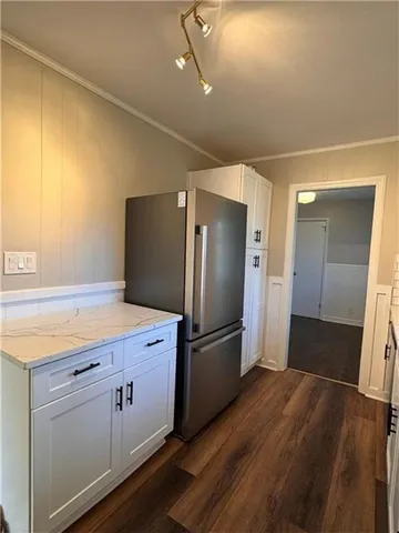 a kitchen with a refrigerator and a sink