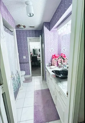 a bathroom with a toilet a sink and a shower