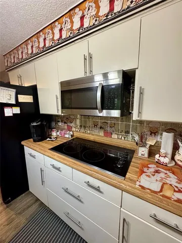 a living room with furniture fireplace and gym equipment