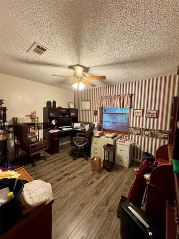 a view of a patio with table and chairs and potted plants with wooden fence