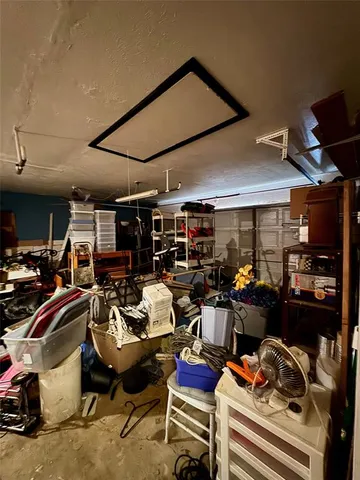 a view of a backyard with table and chairs under an umbrella