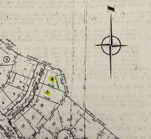 a room with lots of white furniture and a chandelier