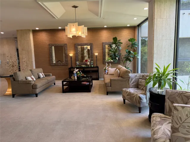 a living room with furniture and large windows