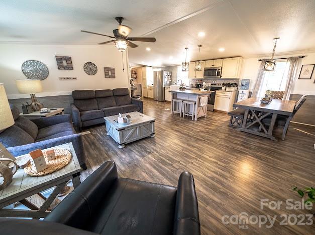 8331 Hills-View Road Oakboro, NC 28129 - Photo 21 of 34 a living room with couches and kitchen view with wooden floor