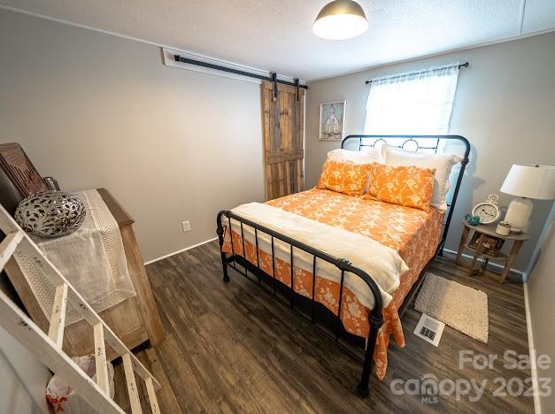 8331 Hills-View Road Oakboro, NC 28129 - Photo 26 of 34 a bedroom with a bed and wooden floor