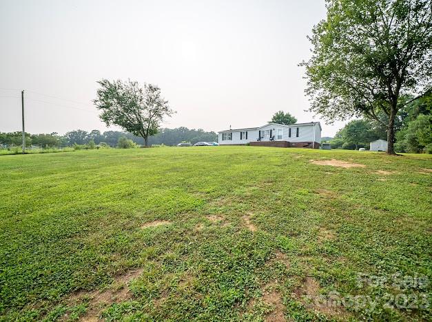 8331 Hills-View Road Oakboro, NC 28129 - Photo 5 of 34 a view of a big yard with a house