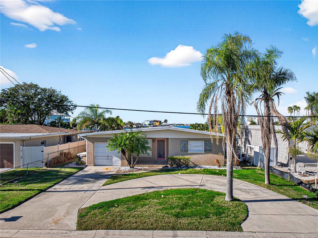 406 161st Avenue Redington Beach, FL 33708 - Photo 2 of 21 a front view of a house with a yard and potted plants