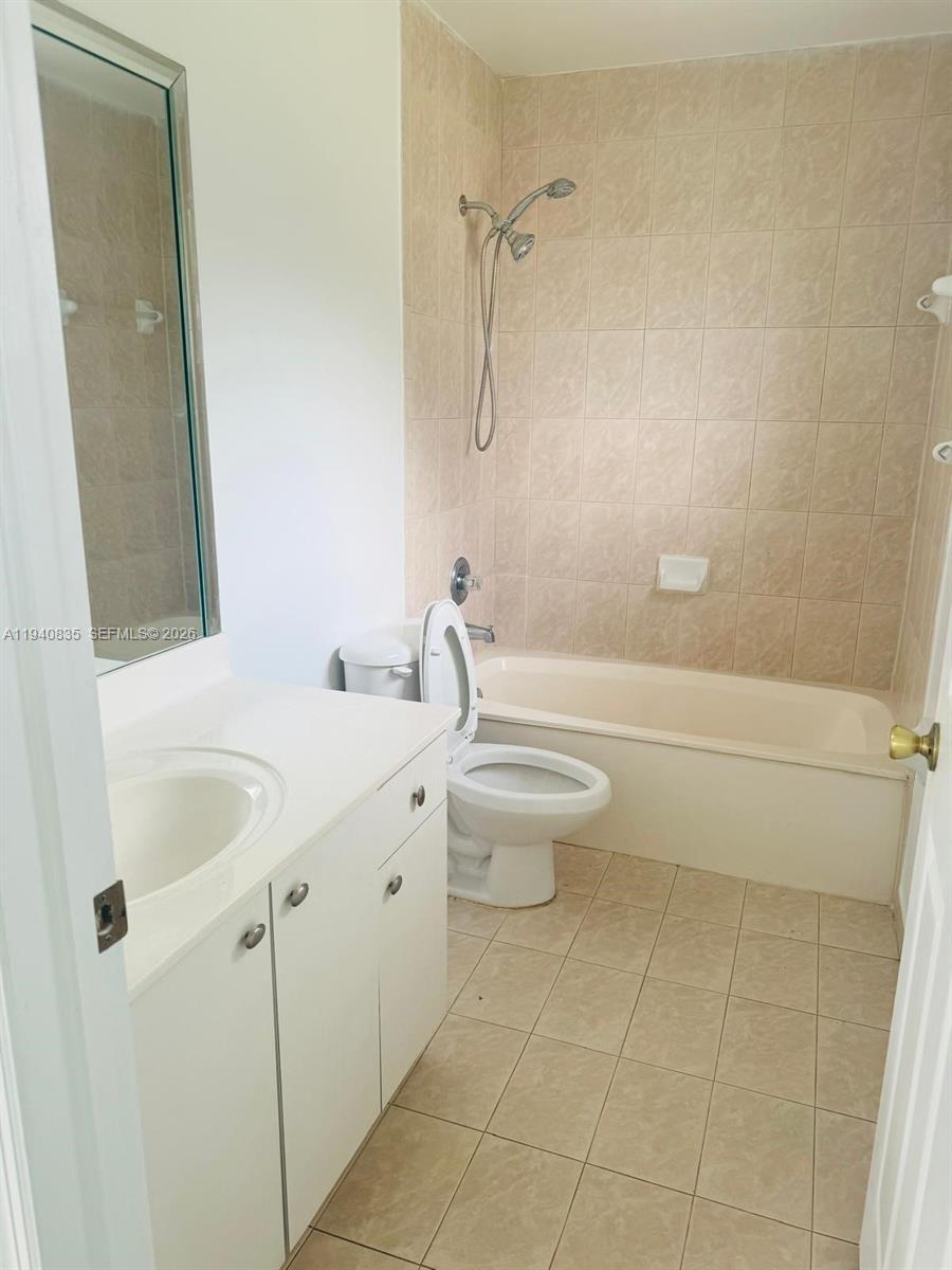 12601 Southwest 223rd Street Miami, FL 33170 - Photo 7 of 11 a bathroom with a granite countertop sink a toilet and shower