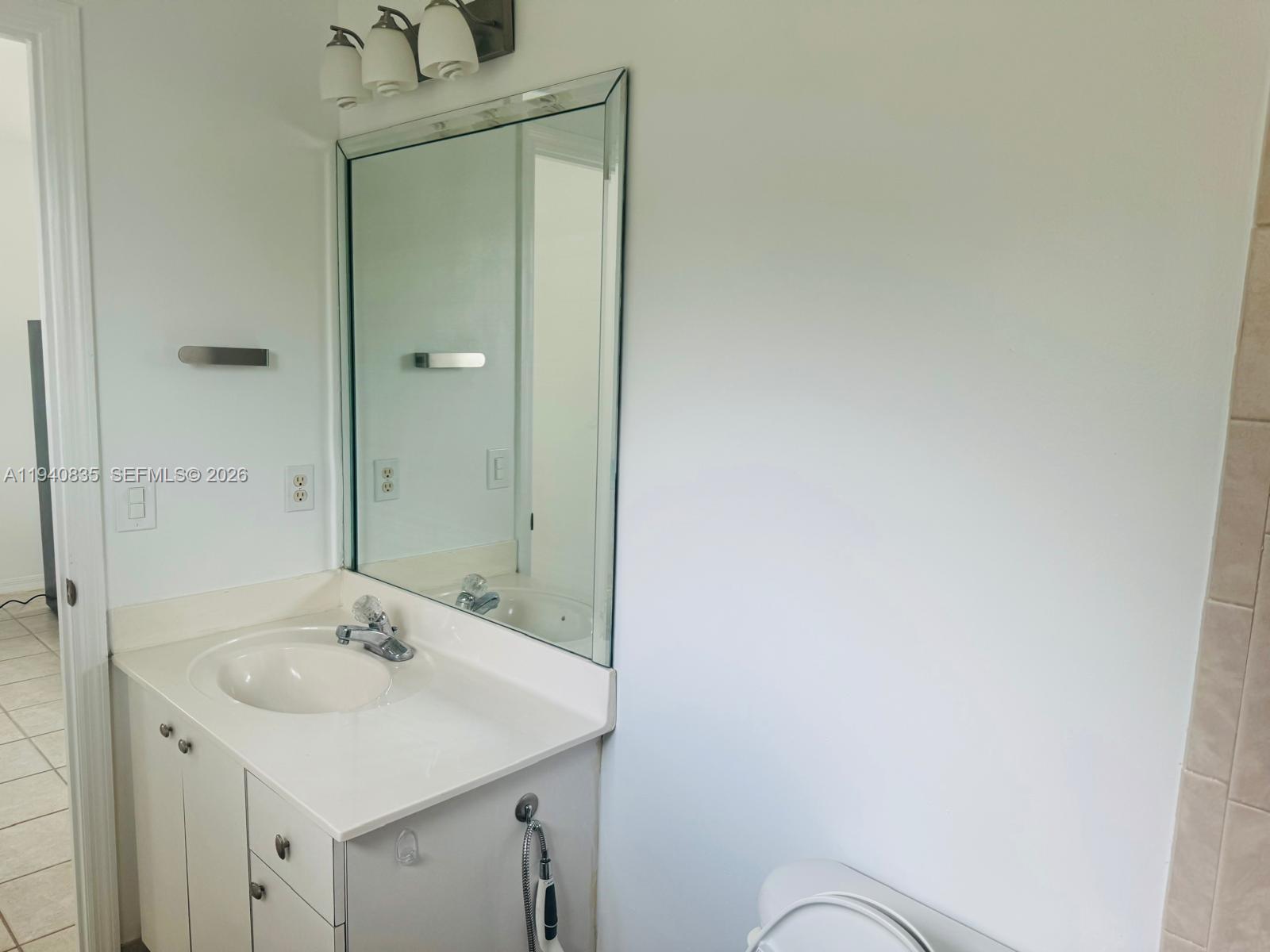 12601 Southwest 223rd Street Miami, FL 33170 - Photo 8 of 11 a bathroom with a sink and a mirror