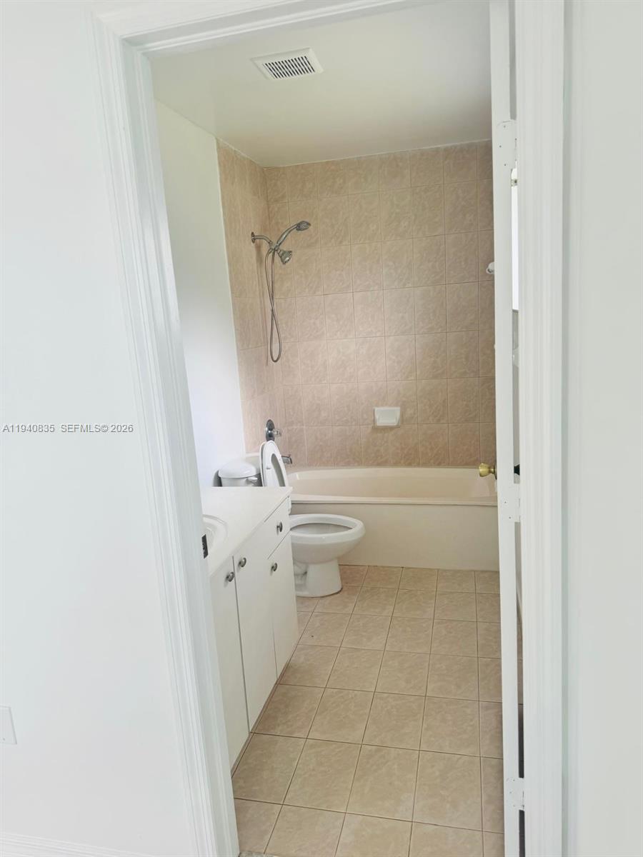 12601 Southwest 223rd Street Miami, FL 33170 - Photo 10 of 11 a bathroom with a granite countertop sink toilet and shower