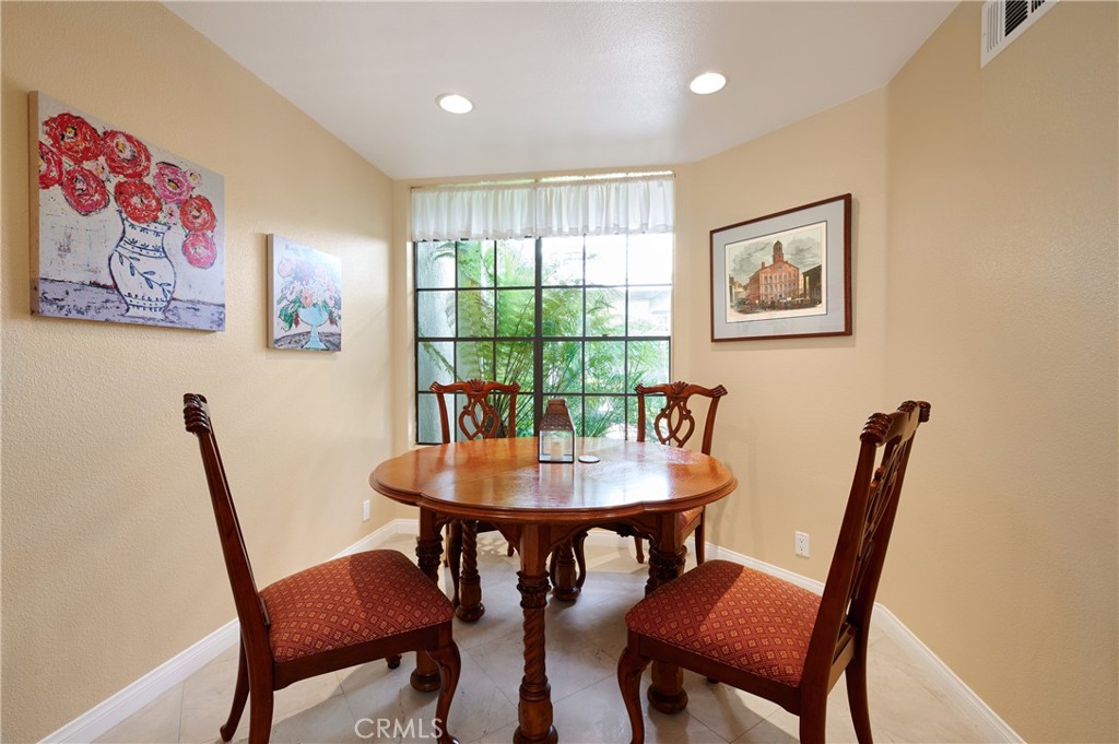 4 Lucerne, Unit 22 Newport Beach, CA 92660 - Photo 11 of 23 a view of a dining room with furniture and a potted plant