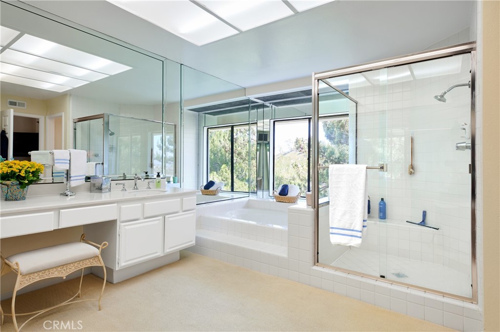 4 Lucerne, Unit 22 Newport Beach, CA 92660 - Photo 18 of 23 a bathroom with a tub sink and mirror