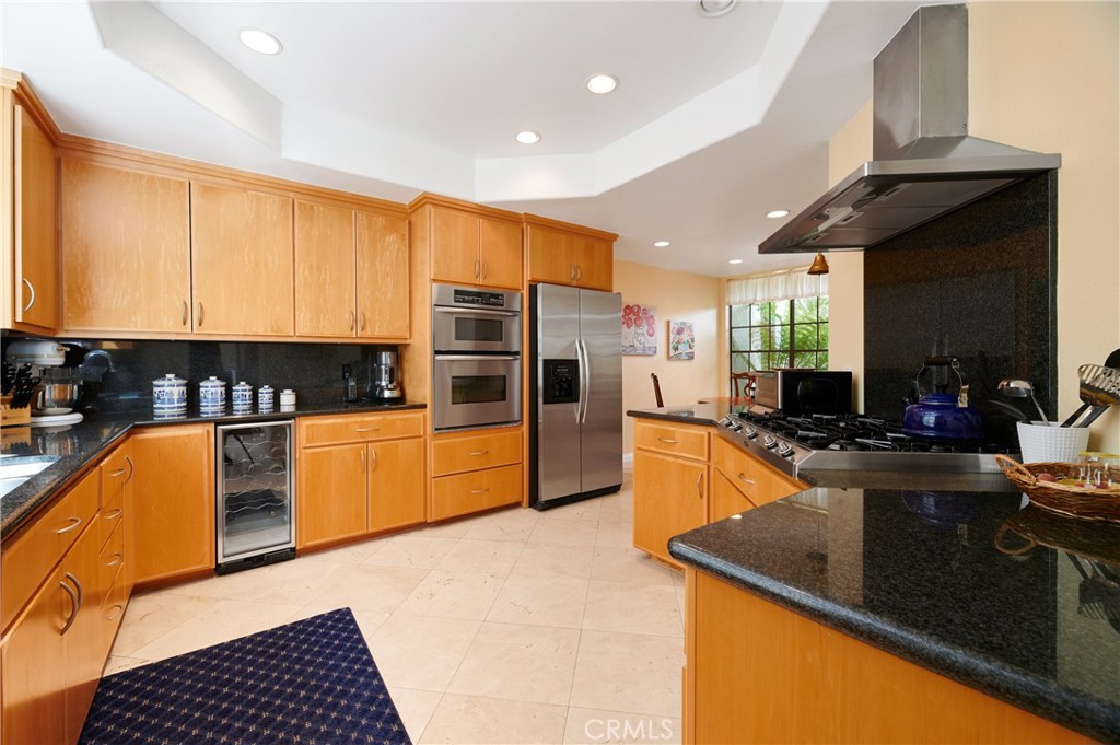4 Lucerne, Unit 22 Newport Beach, CA 92660 - Photo 10 of 23 a kitchen with stainless steel appliances granite countertop a sink a stove and cabinets