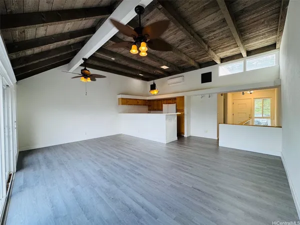 a view of an empty room with wooden floor