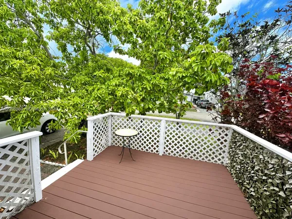 a balcony with wooden floor and fence