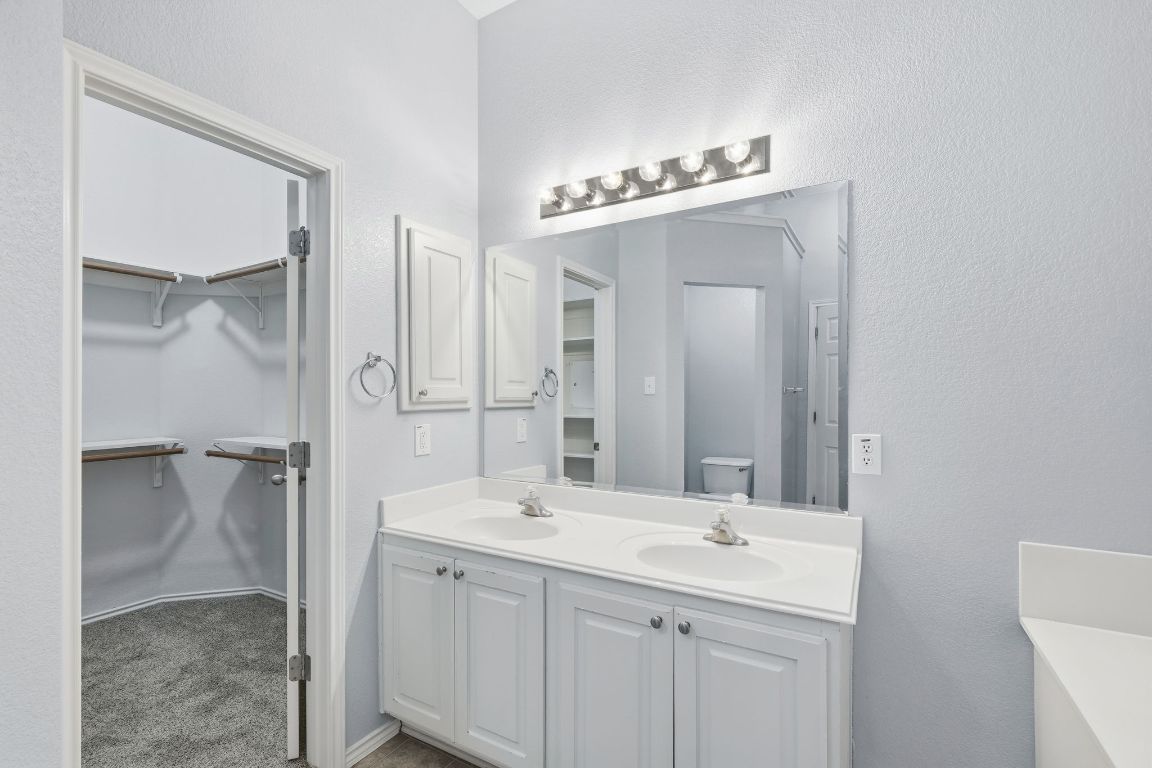 1910 Rachel Lane Round Rock, TX 78664 - Photo 11 of 17 a bathroom with a double vanity sink mirror and toilet