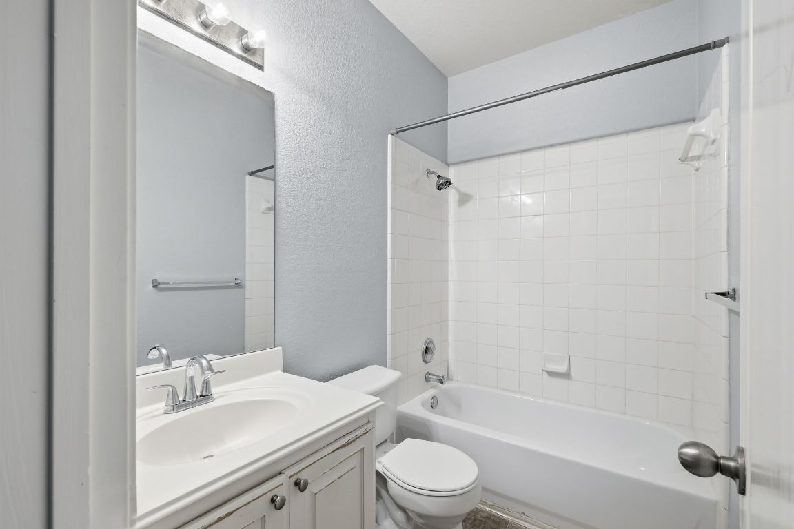 1910 Rachel Lane Round Rock, TX 78664 - Photo 13 of 17 a bathroom with a sink a toilet and shower