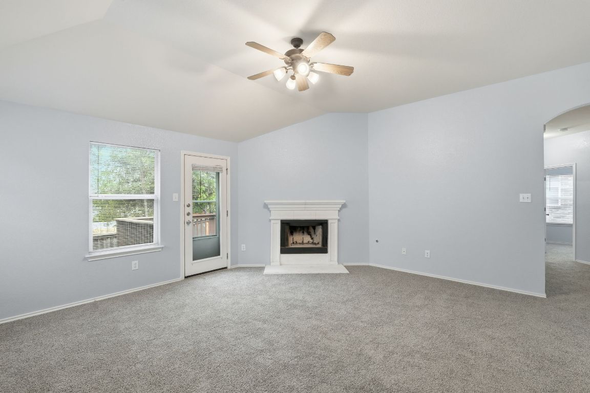 1910 Rachel Lane Round Rock, TX 78664 - Photo 7 of 17 an empty room with chandelier fan and windows