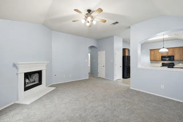 a view of an empty room with a kitchen