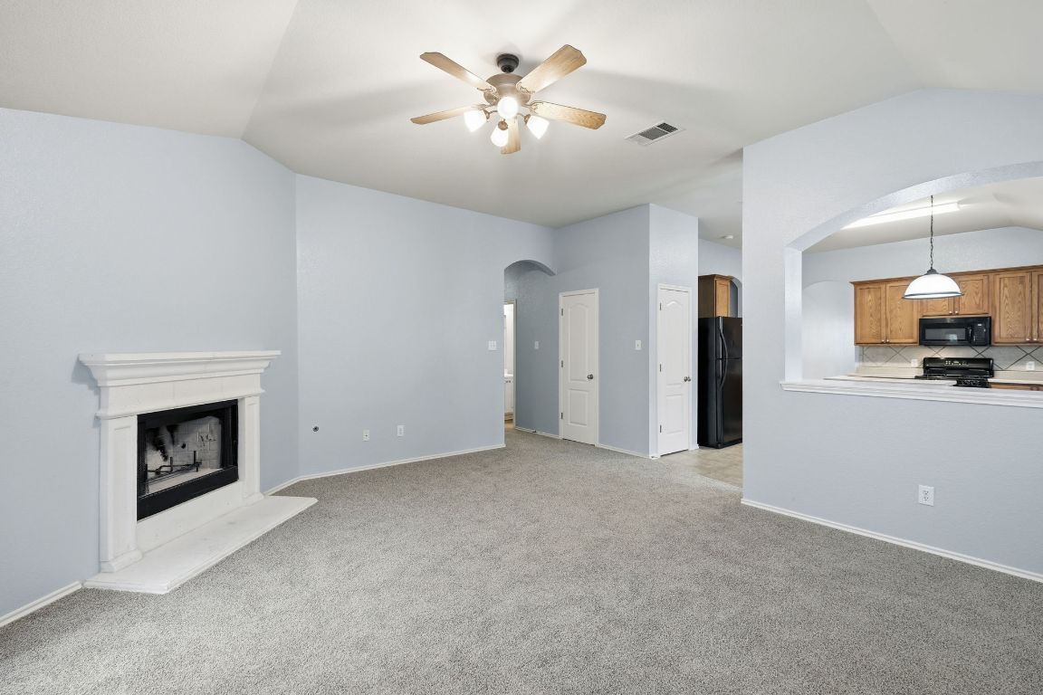 1910 Rachel Lane Round Rock, TX 78664 - Photo 8 of 17 a view of an empty room with a kitchen