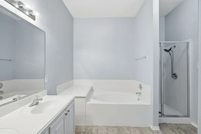 a bathroom with a tub sink and mirror