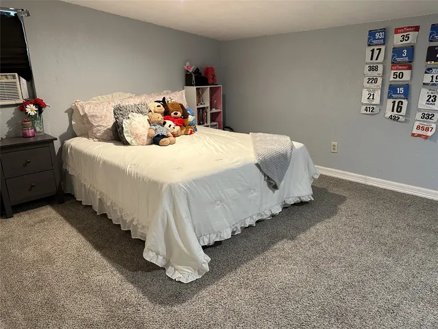 a bedroom with bed and window