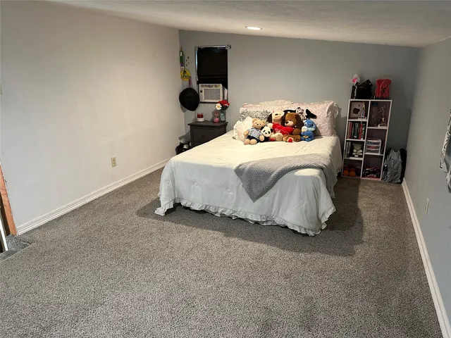 a bedroom with a bed and a book shelf