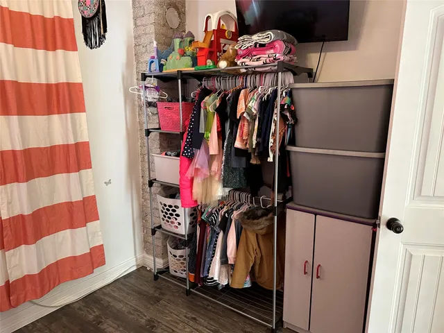 a view of walk in closet with clothes