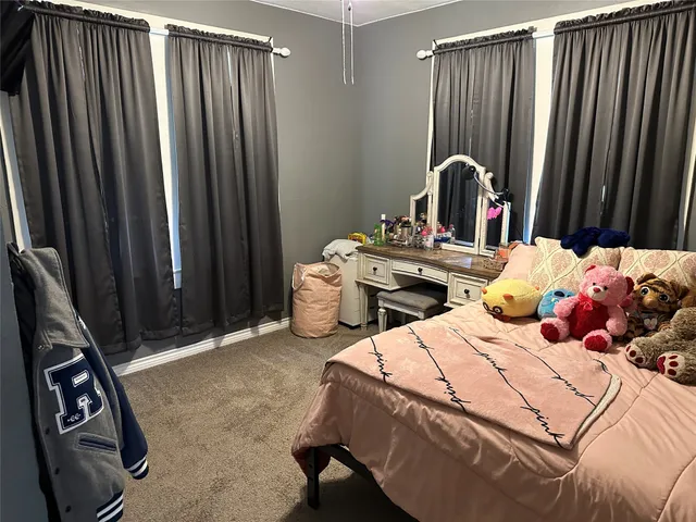 a bedroom with bed and a mirror