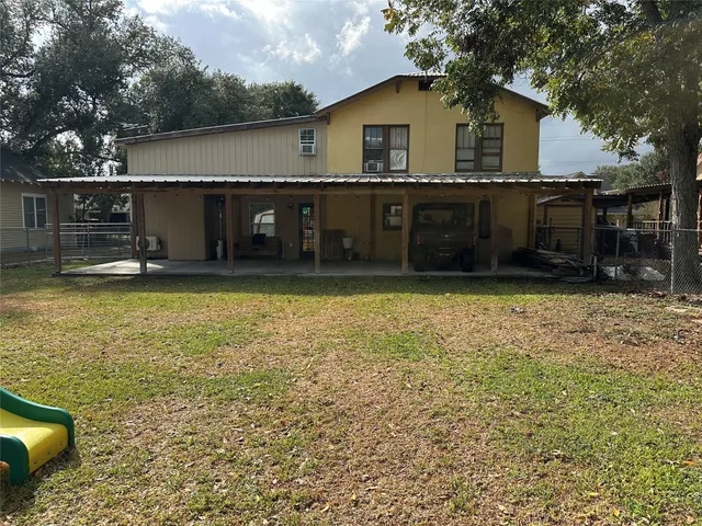 a view of a house with swimming pool next to a yard