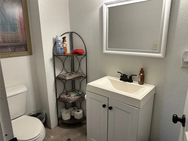 a bathroom with a toilet a sink and a mirror