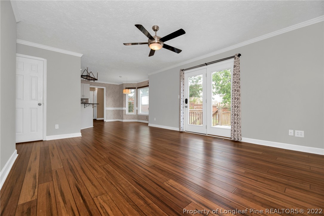 338 Lionshead Road Fayetteville, NC 28311 - Photo 11 of 39 a view of empty room with wooden floor and fan