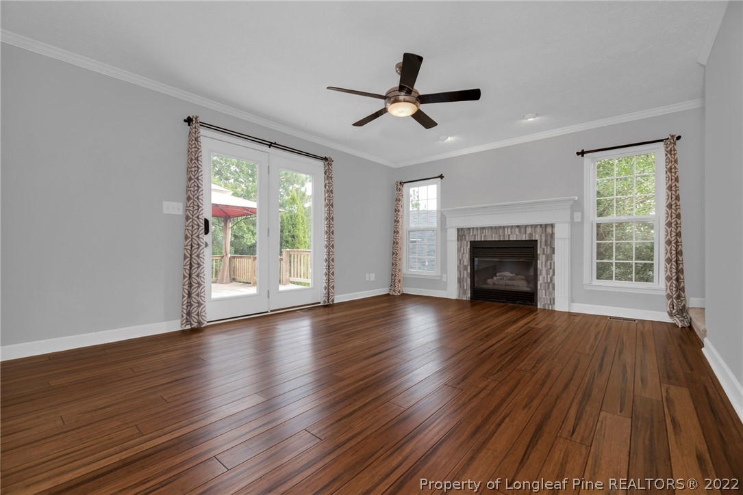 338 Lionshead Road Fayetteville, NC 28311 - Photo 12 of 39 a view of empty room with wooden floor fireplace and a window
