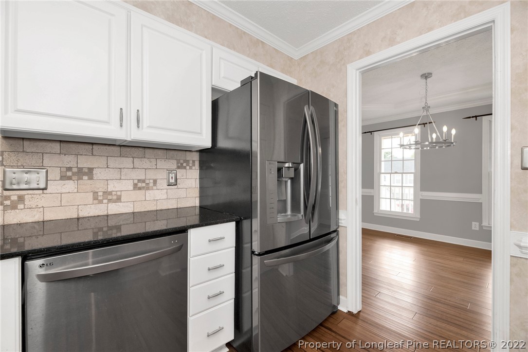 338 Lionshead Road Fayetteville, NC 28311 - Photo 15 of 39 a kitchen with stainless steel appliances granite countertop a refrigerator a sink and white cabinets