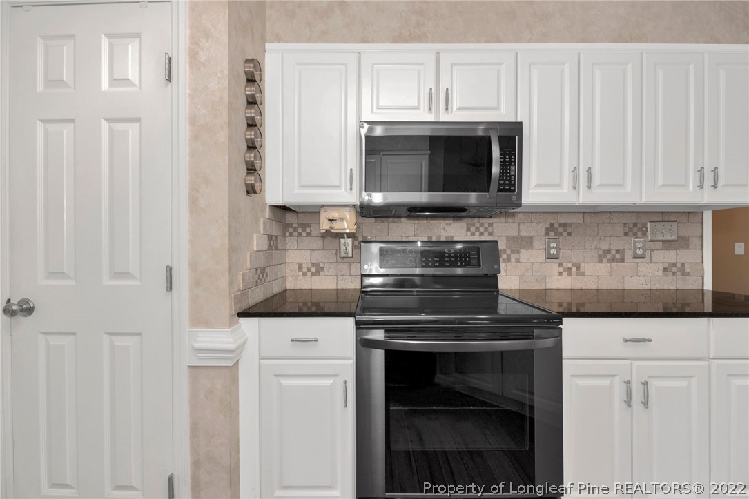 338 Lionshead Road Fayetteville, NC 28311 - Photo 16 of 39 a kitchen with stainless steel appliances granite countertop white cabinets and a stove a oven with white countertops