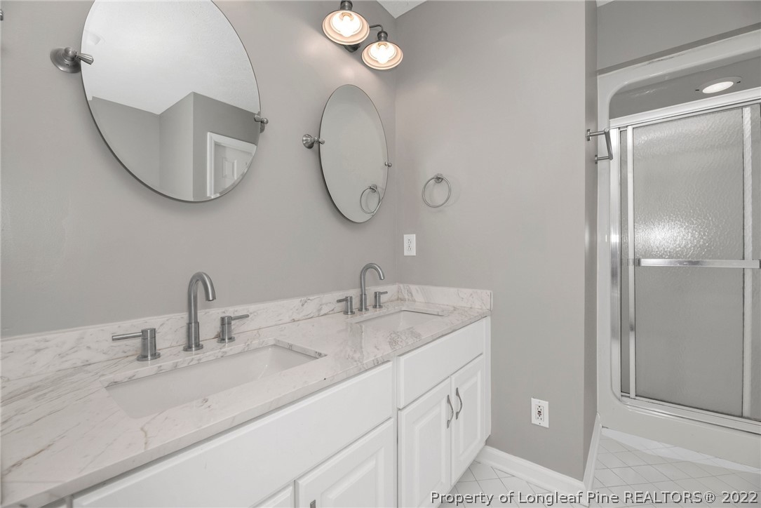 338 Lionshead Road Fayetteville, NC 28311 - Photo 30 of 39 a bathroom with a double vanity sink and a mirror